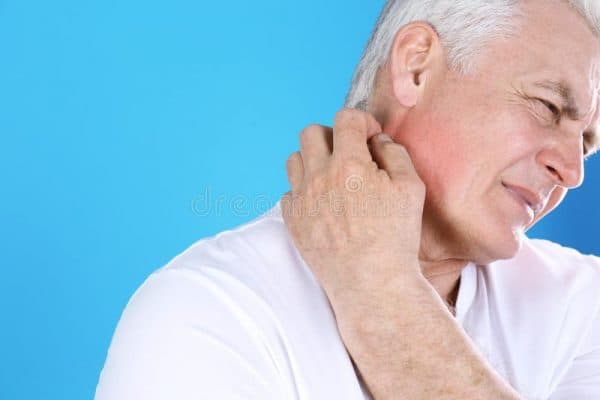 senior man scratching back of neck